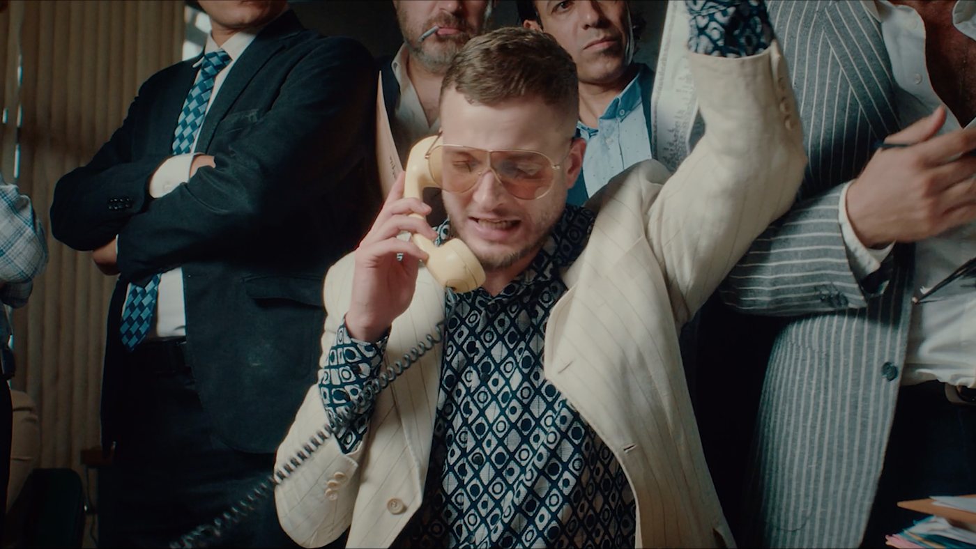 Marwan on the phone, crowded by the film board in Sa7mad